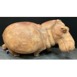 A large African carved hard wood figure, as a Hippopotamus, approx 66cm high, 166cm long, 58cm