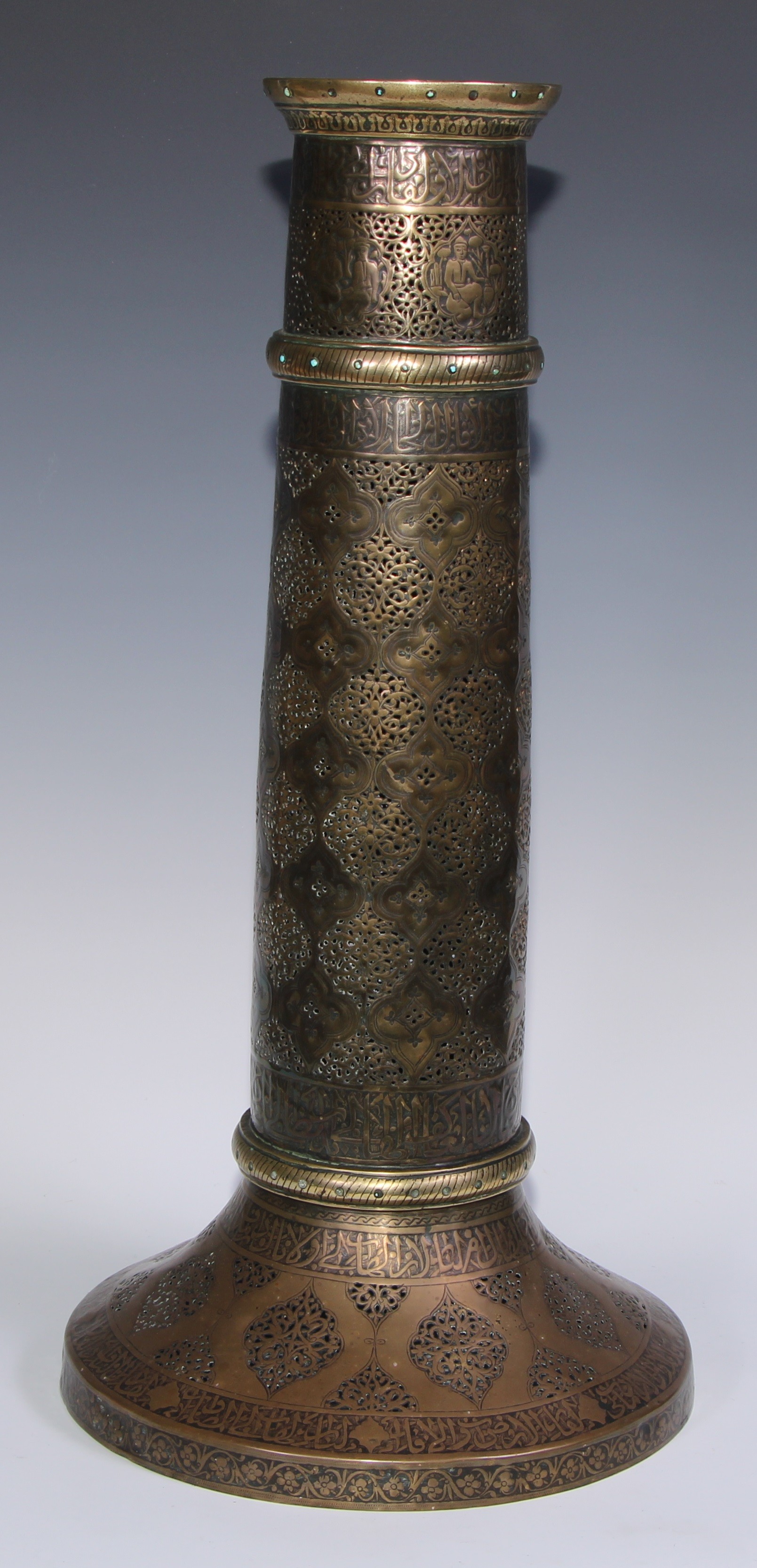 A pair of large Middle Eastern Islamic brass mosque candlesticks, pierced and engraved with a field - Image 5 of 12