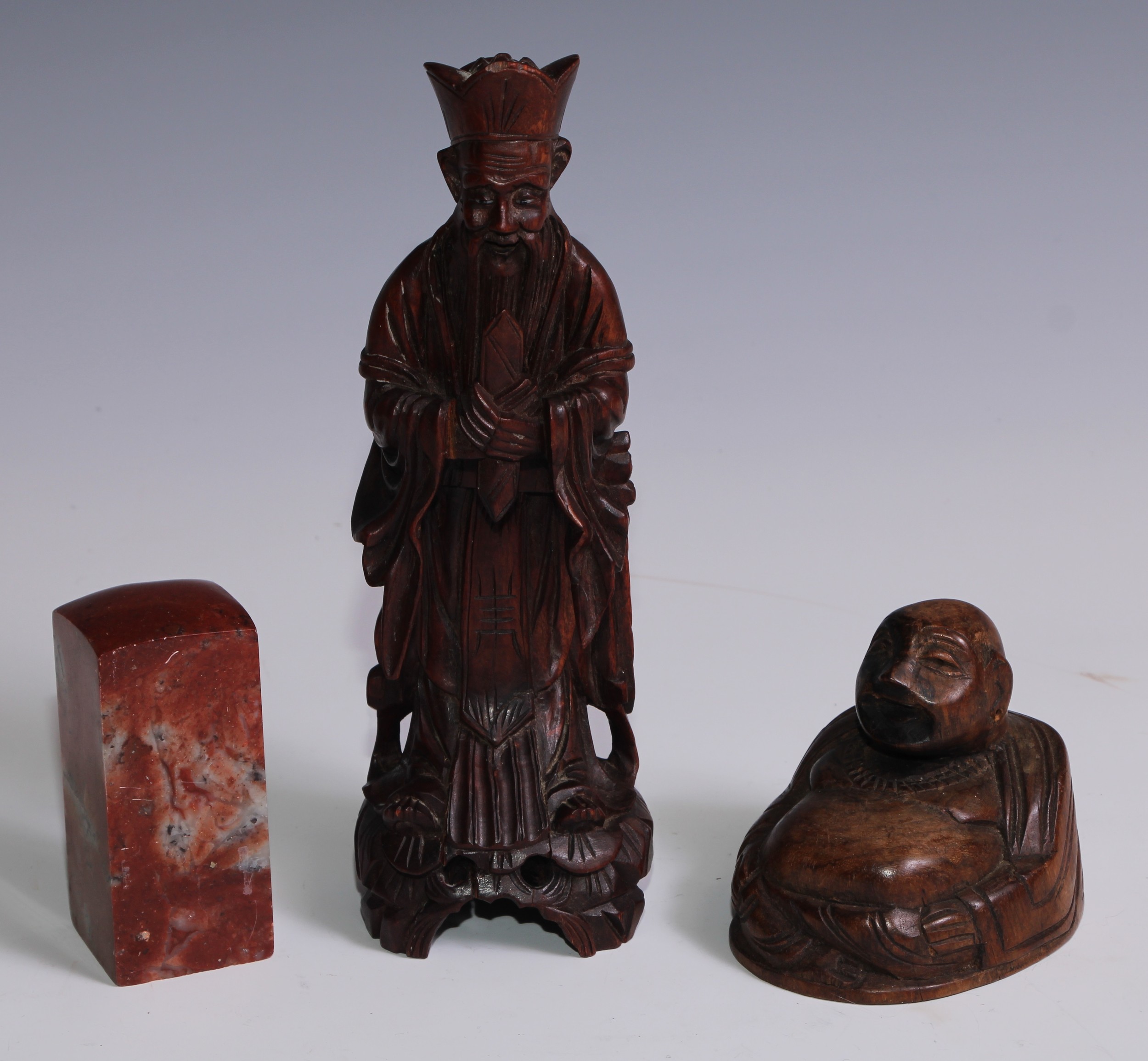 A Chinese soapstone seal, 9.5cm high; a Chinese carved hardwood figure, of an immortal, 23.5cm high;