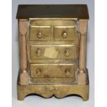 A 19th century brass miniature chest of drawers, possibly Welsh, inverted break centre top above two