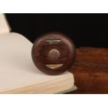 A 19th century turned rosewood bun shaped snuff box, the hinged cover set with a rose gold