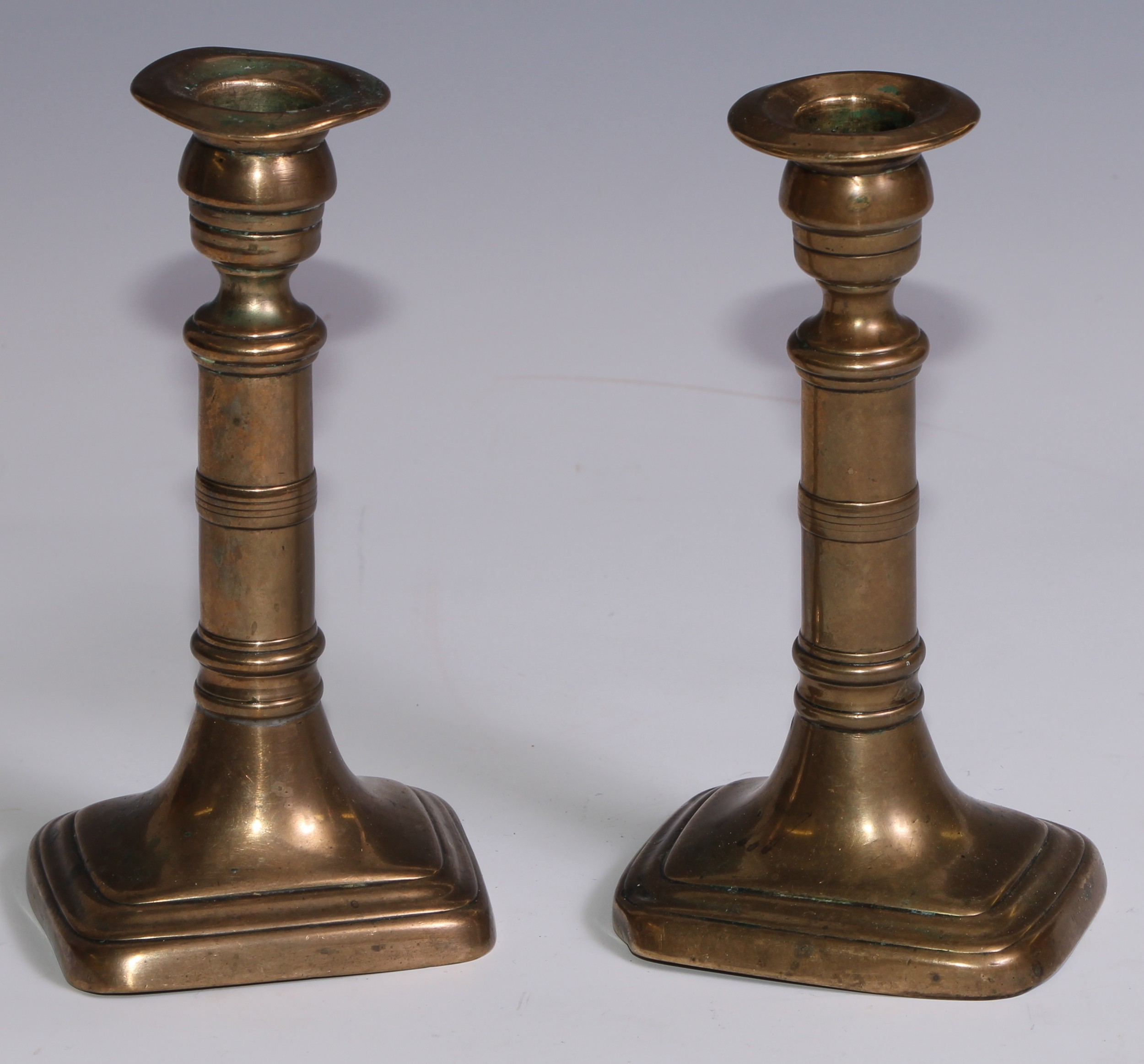 The Duke of Wellington and the Napoleonic Wars - a pair of George III brass candlesticks, campana