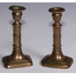 The Duke of Wellington and the Napoleonic Wars - a pair of George III brass candlesticks, campana