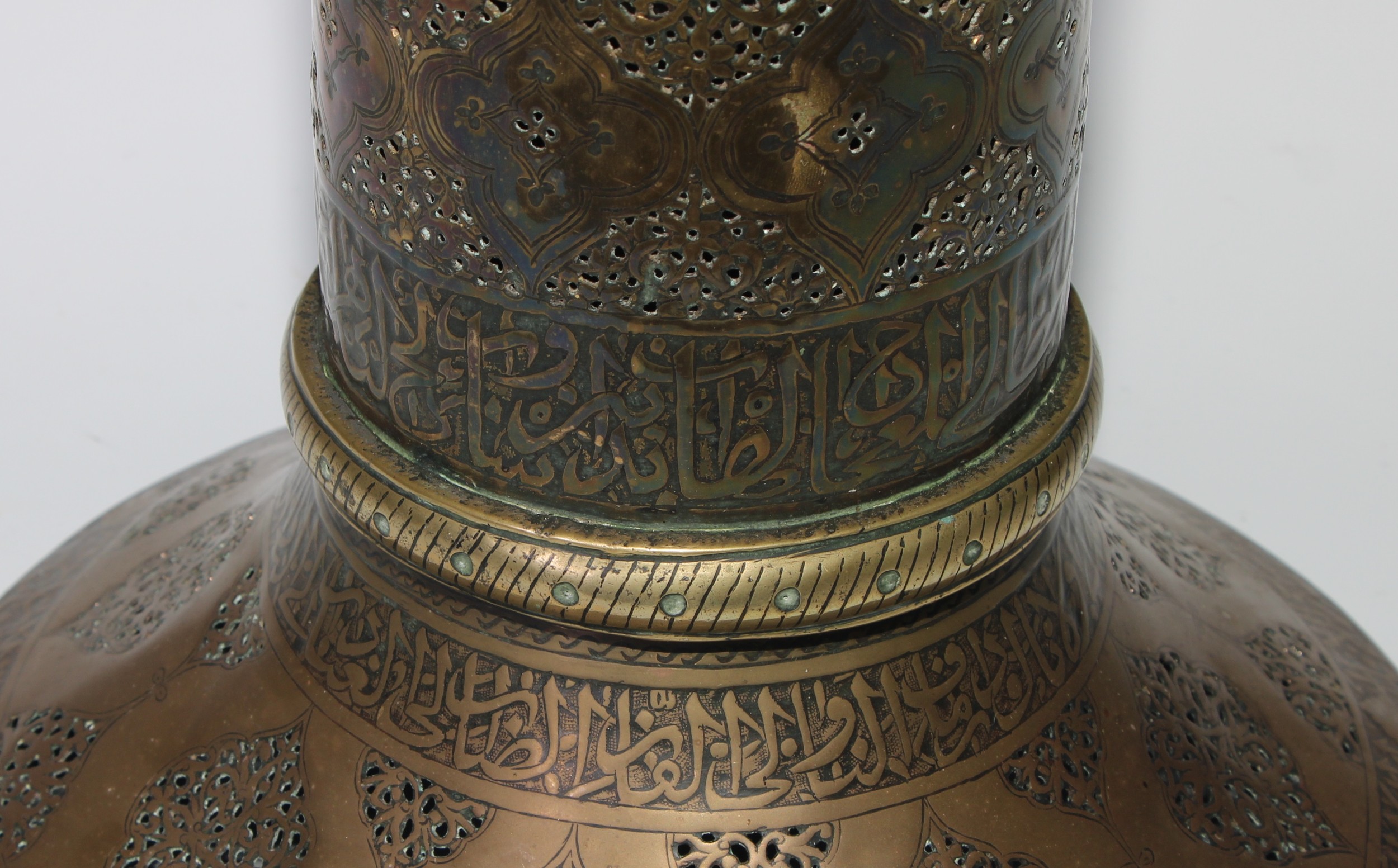 A pair of large Middle Eastern Islamic brass mosque candlesticks, pierced and engraved with a field - Image 8 of 12