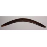 An Australian Aboriginal boomerang, carved with kangaroos and emus, 55cm long