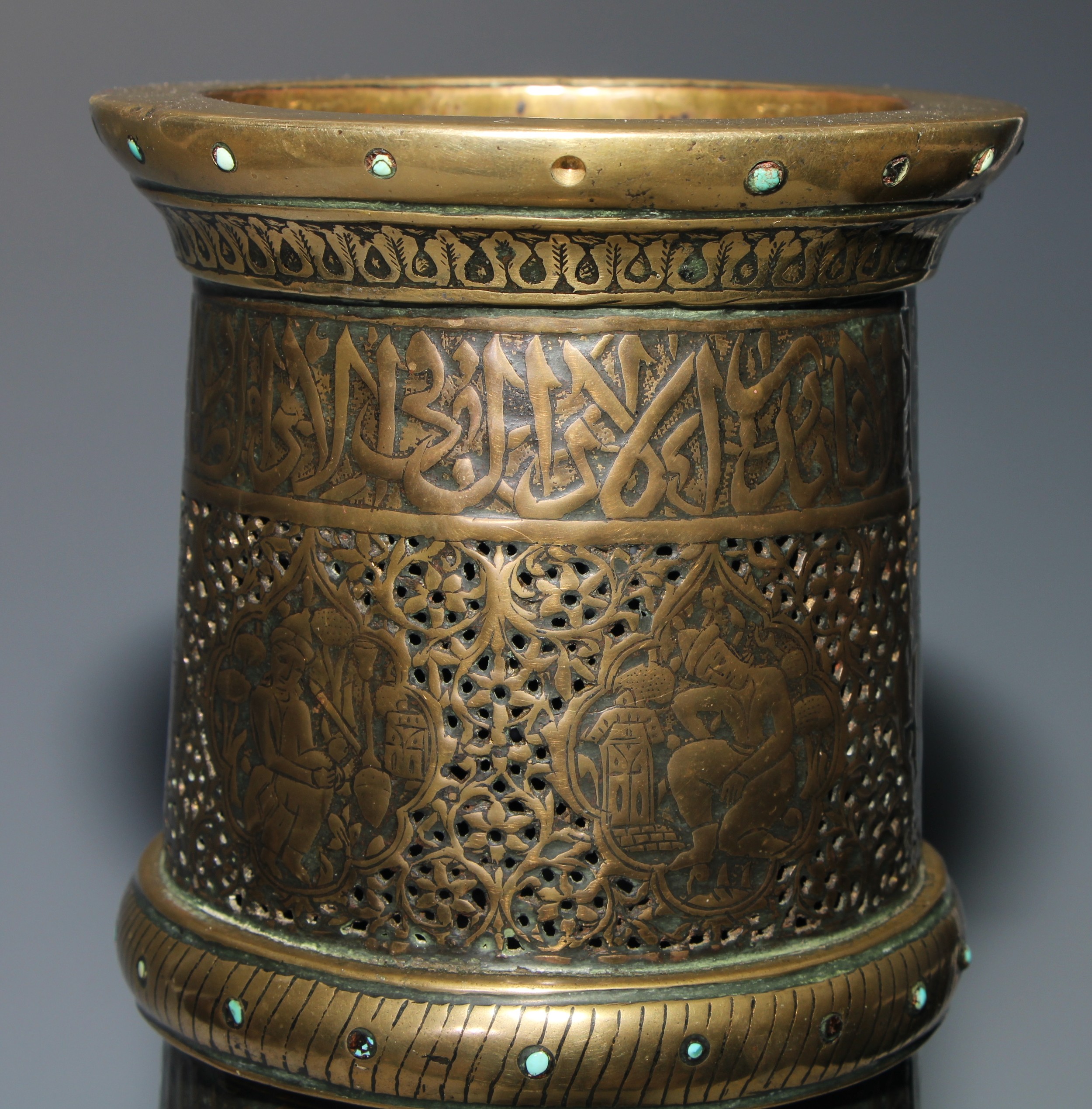 A pair of large Middle Eastern Islamic brass mosque candlesticks, pierced and engraved with a field - Image 7 of 12