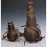 Tribal Art - an African water gourd, the straps applied with cowrie shells, 27cm long; another,