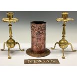 A pair of Arts and Crafts brass candlesticks, by Benham & Froud, London, stylised leafy drip pan,