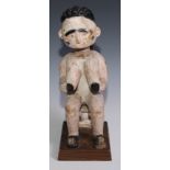 Tribal Art and the Eclectic Interior - an Ashanti figure, carved as a female seated on a stool,