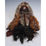 Tribal Art - a Kuba mask, applied with cowrie shells, hair and fibre, 57cm long, Democratic Republic