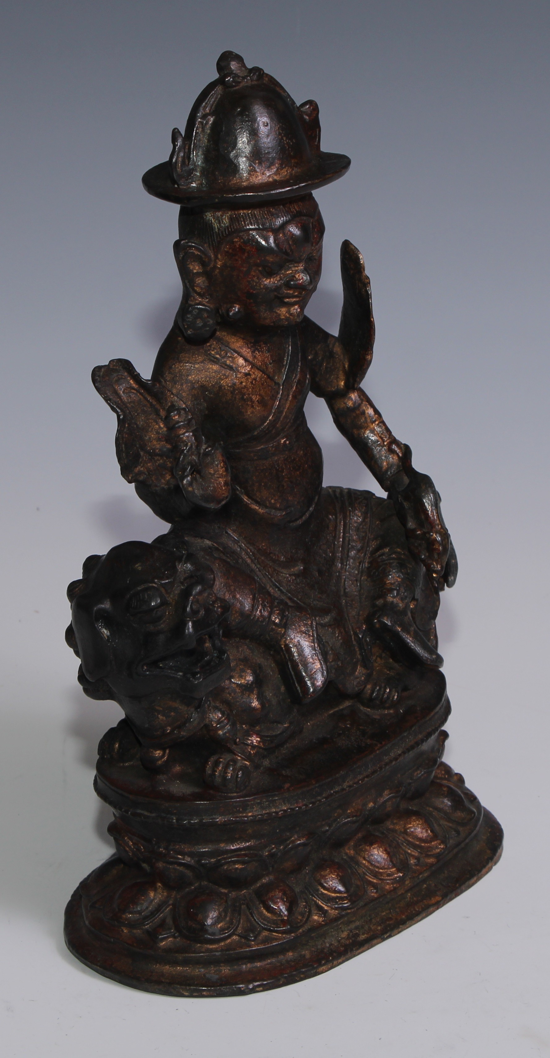 Tibetan School, a red and gilt patinated bronze, Vajrasadhu seated on a lion, lotus base, 28cm high - Image 2 of 4