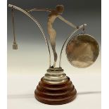 An Art Deco dinner gong, as a flapper girl in silhouette, stepped base, 27cm high