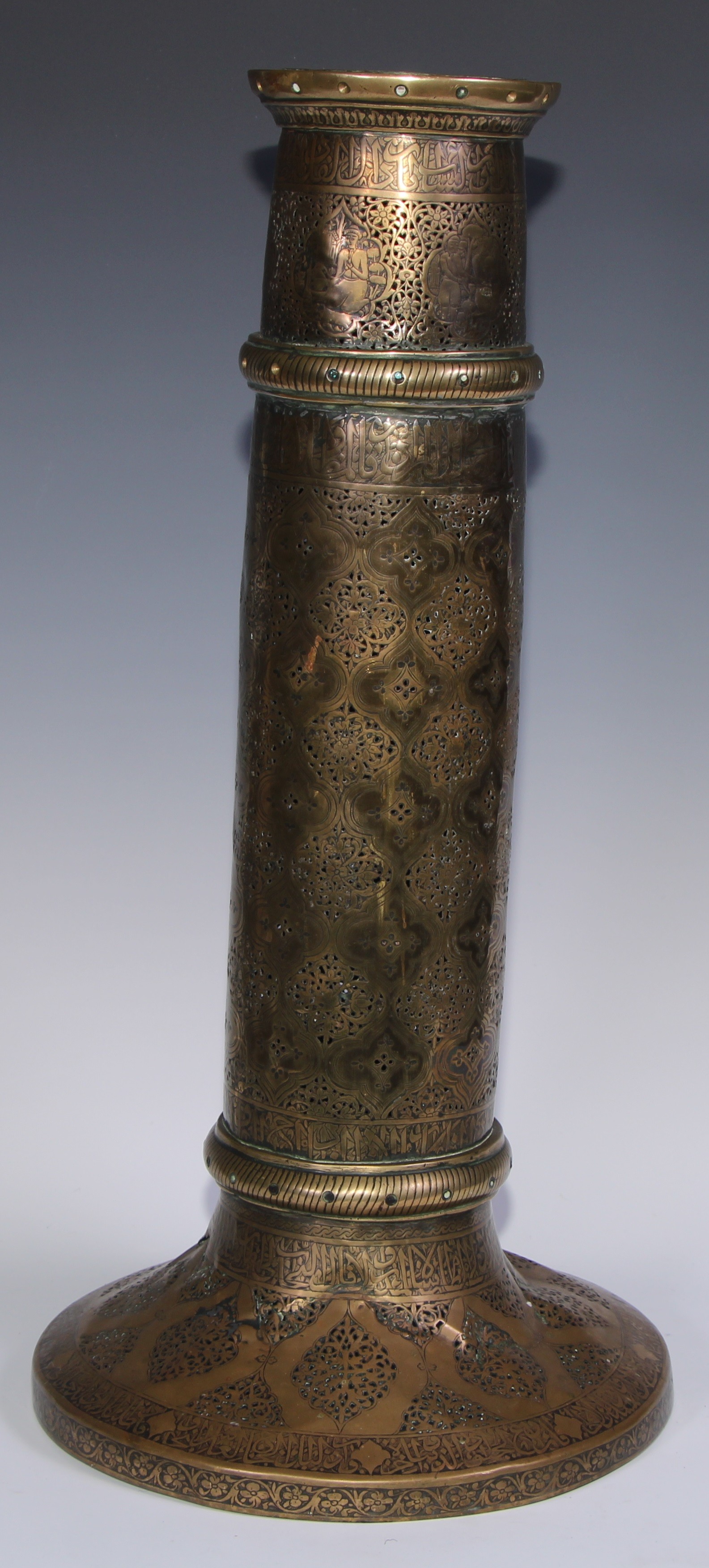 A pair of large Middle Eastern Islamic brass mosque candlesticks, pierced and engraved with a field - Image 12 of 12