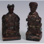 A pair of Chinese lacquer figures, of Immortals, each enthroned, 15cm high