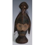 Tribal Art - a Baule carving, of a head, wearing a mask and avian headress, 26cm high, Ivory