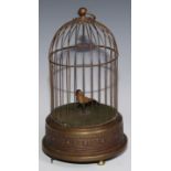 A brass clockwork novelty automaton, as a singing bird in a cage, suspension loop, 29cm high, 20th