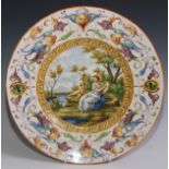 A 19th century tin glazed earthenware charger, painted in polychrome in the Istoriato taste, 40.