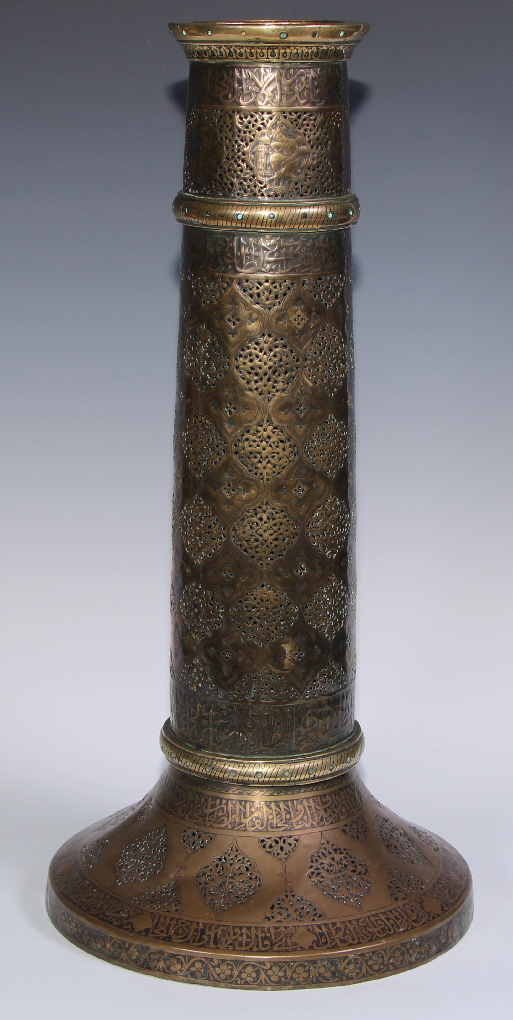 A pair of large Middle Eastern Islamic brass mosque candlesticks, pierced and engraved with a field - Image 6 of 12