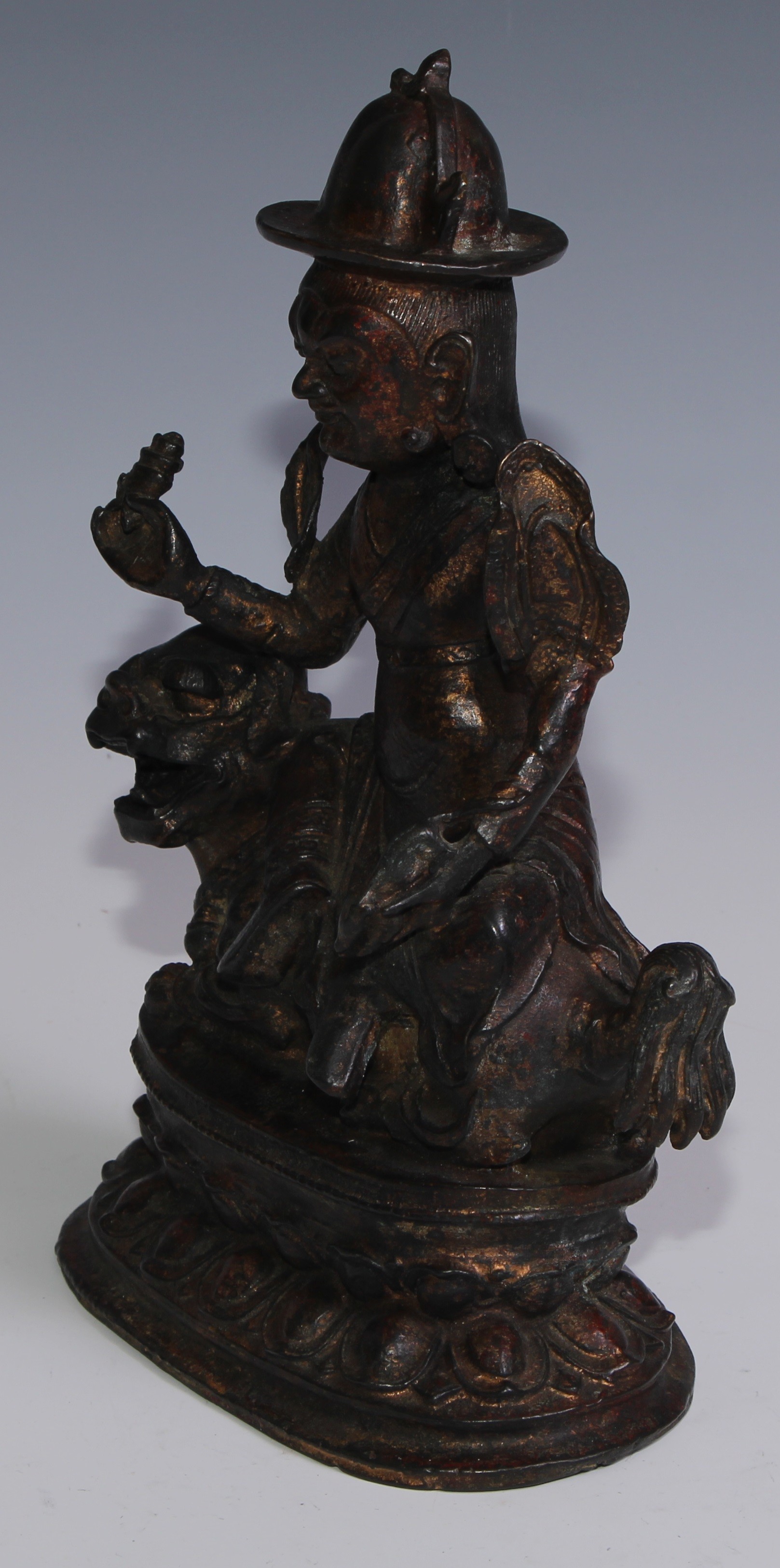 Tibetan School, a red and gilt patinated bronze, Vajrasadhu seated on a lion, lotus base, 28cm high - Image 3 of 4