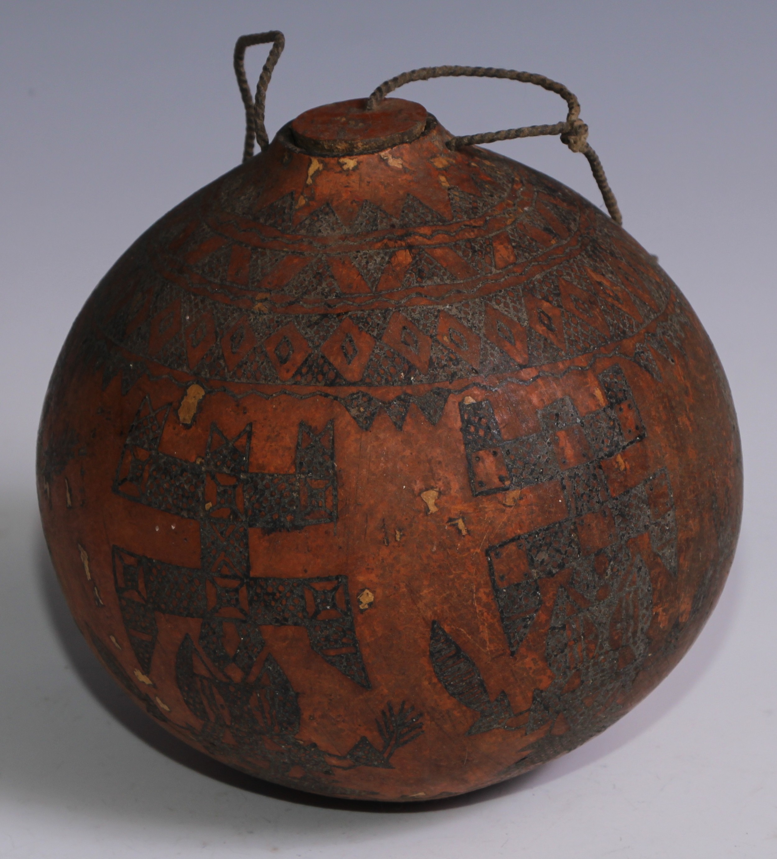 A South American gourd vessel, sgrafitto decorated, 14cm high