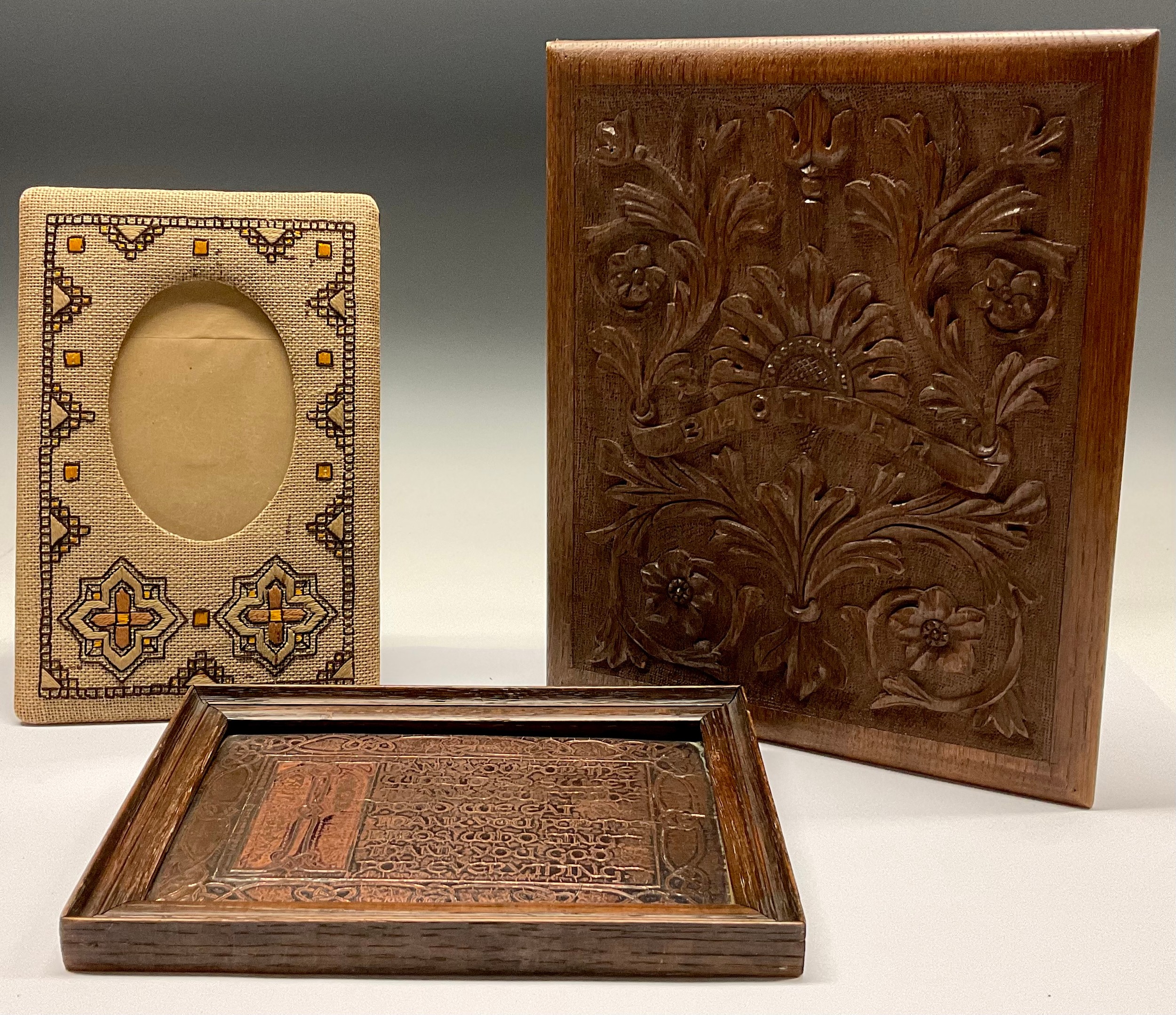 An Arts and Crafts carved oak blotter, 32cm x 27cm; a copper plaque, Thank You For The World So