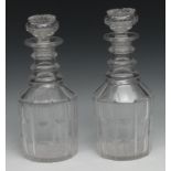 A pair of 19th century mallet shaped clear glass decanters, triple ring neck, globular and star