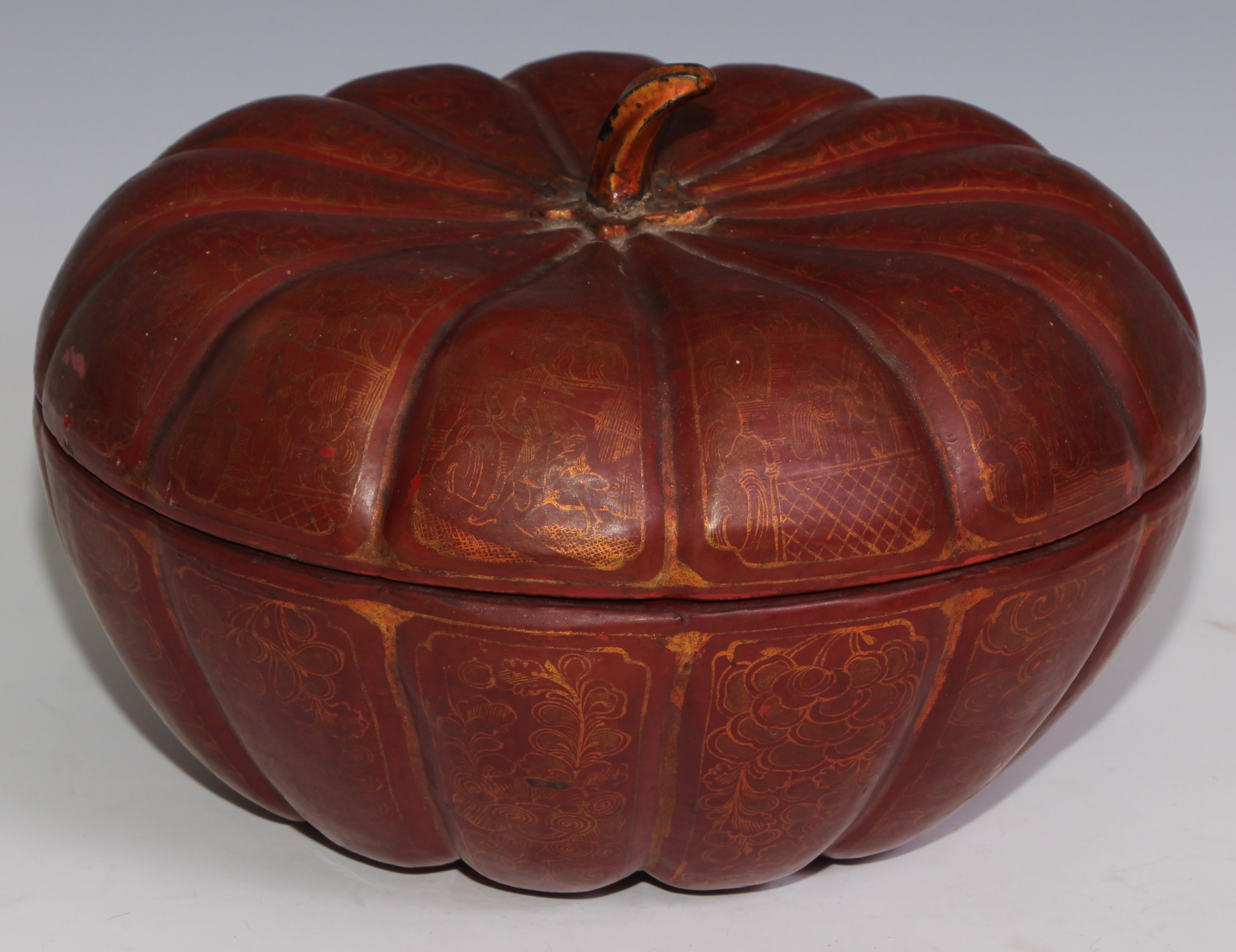 A Chinese lacquer melon shaped box and cover, enclosing a lift-out tray with an arrangement of