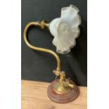 A 19th century brass swan neck gas wall light, later converted to electricity, fluted opaque glass