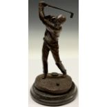 A desk bronze, of a golfer taking a swing, circular marble base, 23.5cm high