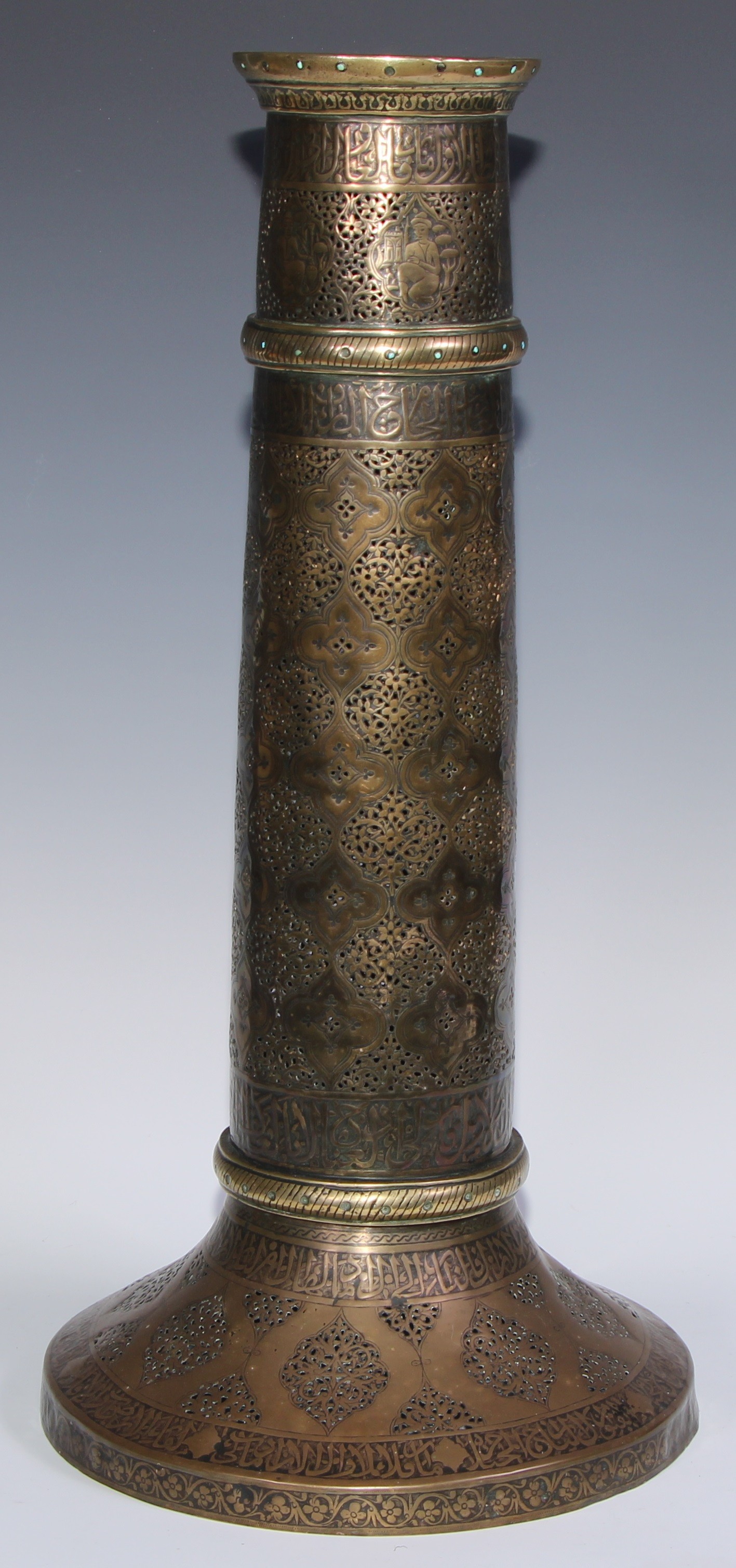 A pair of large Middle Eastern Islamic brass mosque candlesticks, pierced and engraved with a field - Image 2 of 12