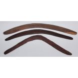 Tribal Art - an Australian Aboriginal boomerang, textured surface, traces of red pigment, 60cm long;