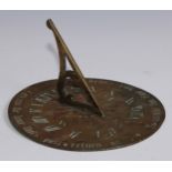 A Victorian brass sun dial, engraved with Roman numerals within a band of verse in Gothic font, Be