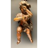 A Baroque softwood carving, of a scantily clad putto, 39cm long, 18th/19th century