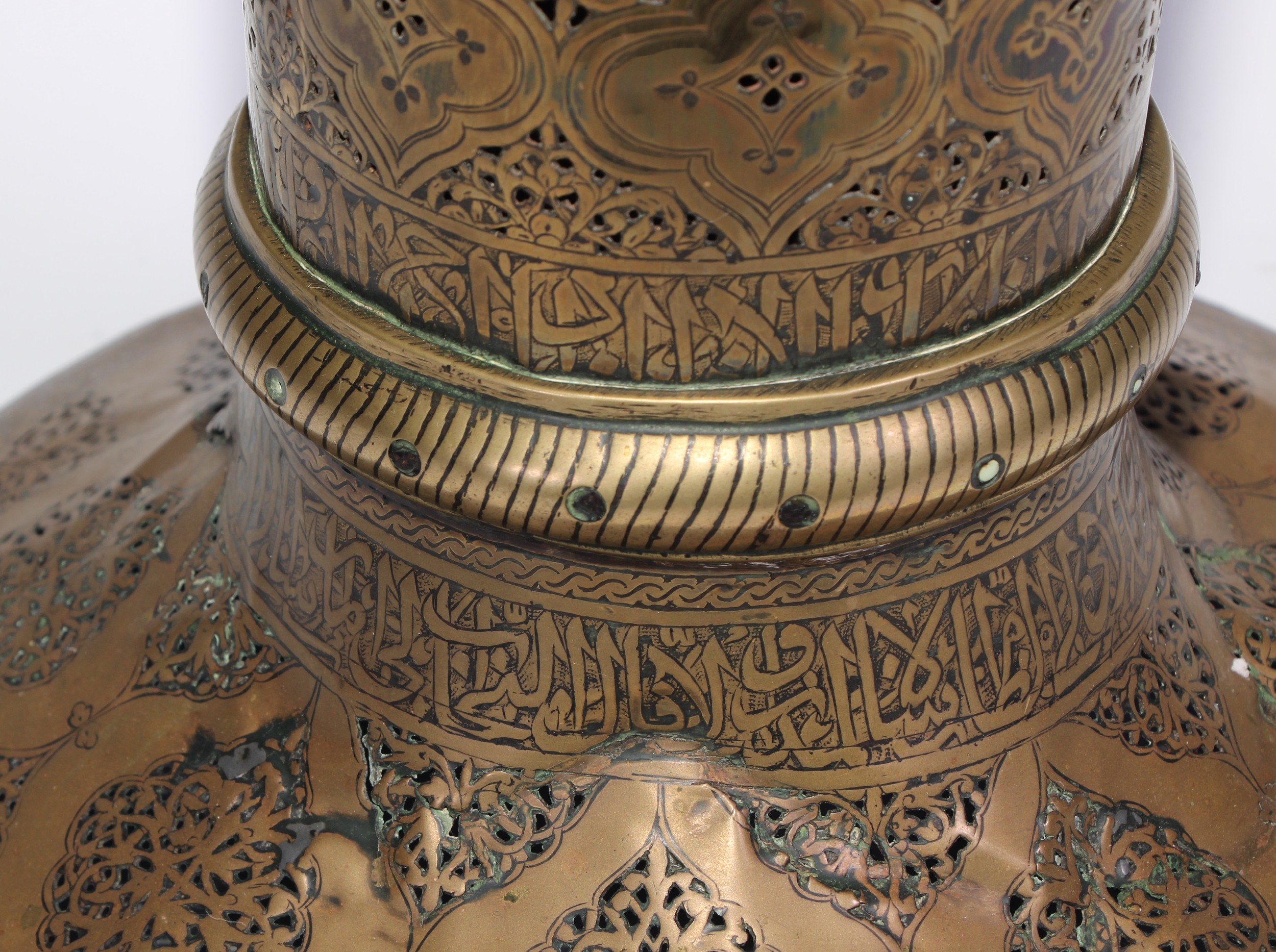 A pair of large Middle Eastern Islamic brass mosque candlesticks, pierced and engraved with a field - Image 3 of 12