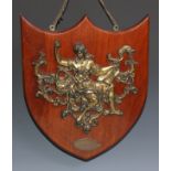 A 19th century gilt metal appliqué, cast as a muse allegorical of knowledge, the mahogany shield