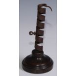 A 19th century iron spiral candlestick, fruitwood base, 20cm high