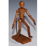 An early 20th century articulated artist’s lay figure, the stand with rectangular base, 28cm high