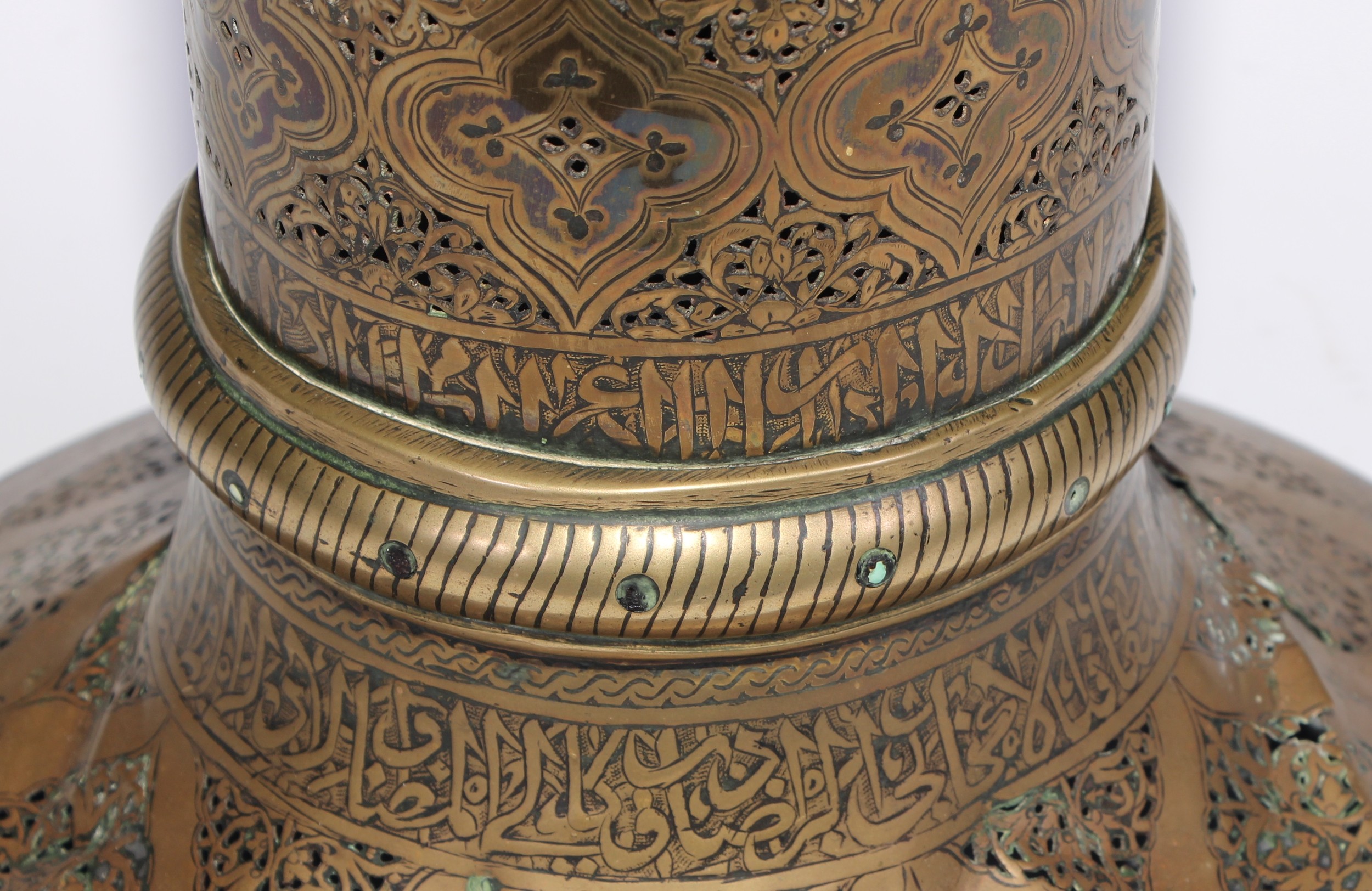 A pair of large Middle Eastern Islamic brass mosque candlesticks, pierced and engraved with a field - Image 11 of 12