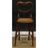An early Victorian faux-rosewood music room chair, kidney shaped back, cane seat, turned legs and