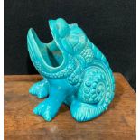 A Burmantofts Faience spoon warmer, as a grotesque seated toad, glazed throughout turquoise, 12.