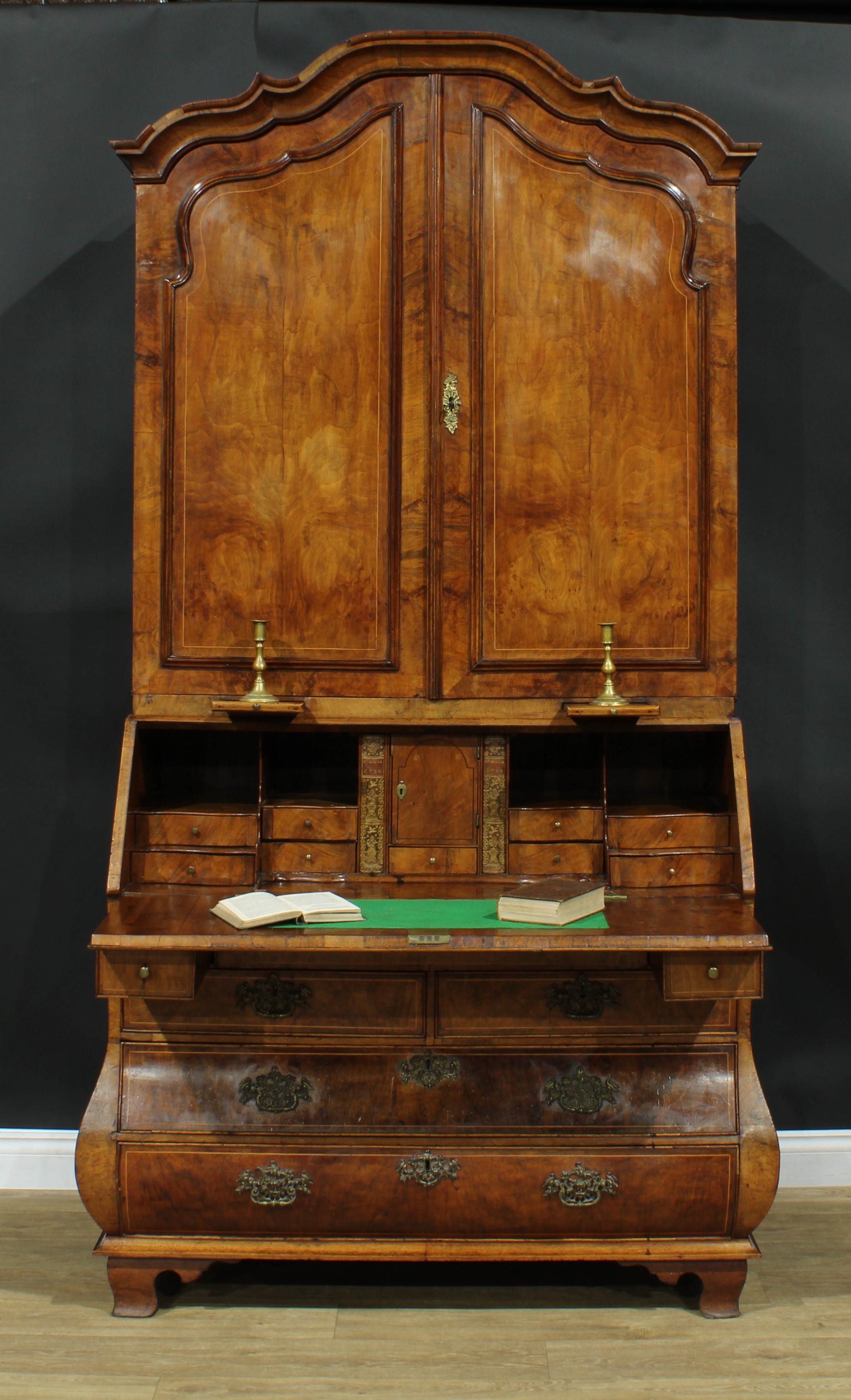 An 18th century Dutch walnut bureau book cabinet, the pair of panel doors above two candle slides