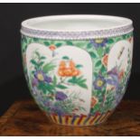 A Chinese ovoid jardiniere, decorated in the famille verte palette with flowers, rock work and