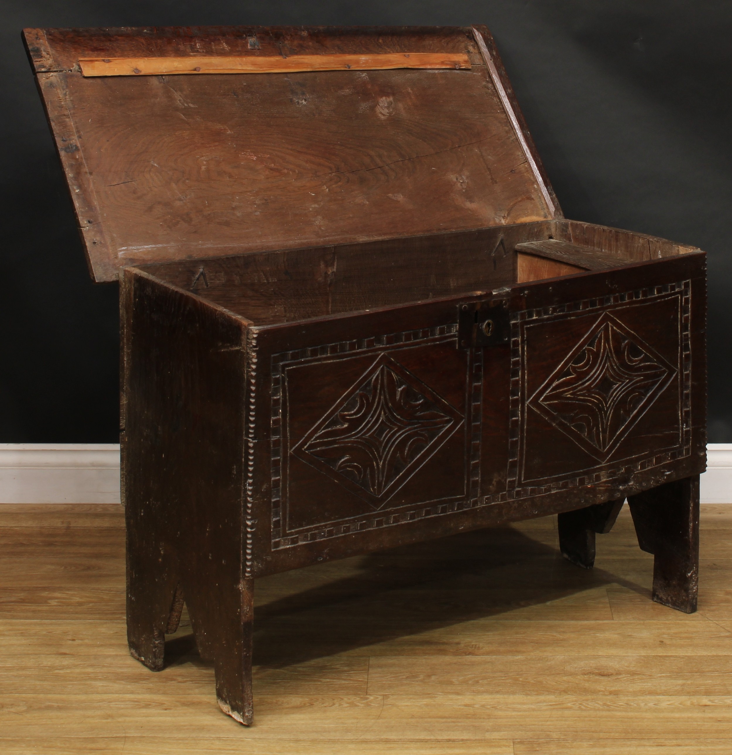 A 17th century elm six plank chest, hinged top enclosing a till, the front carved with leafy - Image 3 of 5