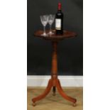 A George III Revival mahogany tripod wine table, dished circular tilting top, turned column, sabre