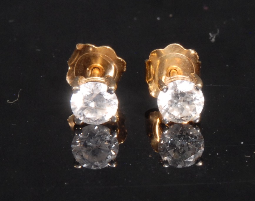 A pair of round brilliant cut diamond ear studs, stamped '750' for 18ct gold, each diamond