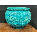 A Burmantofts Faience jardiniere, relief moulded with stylised flowers and foliage with basket weave
