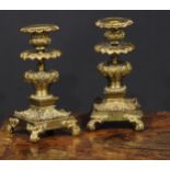 A pair of 19th century gilt bronze candlesticks, cast throughout with scrolling acanthus, 21cm high,