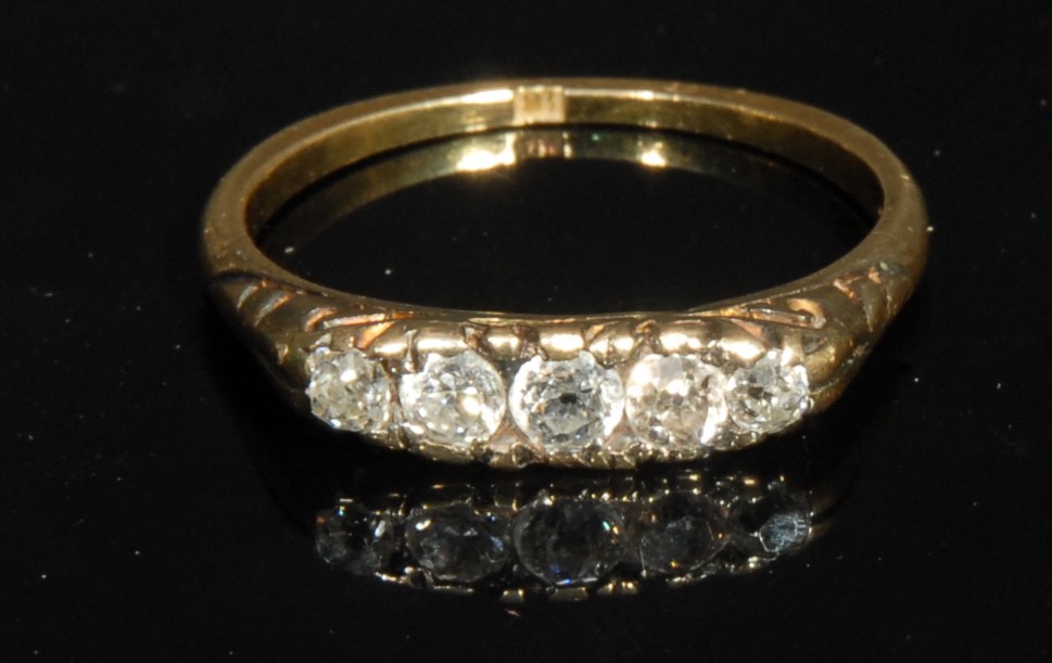 A diamond five stone ring, set in platinum, 18ct gold shank, 2.6g