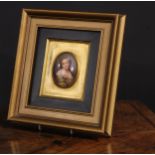 A 19th century Continental porcelain portrait plaque, painted with a young girl in a green shawl,