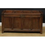 A late 17th century oak blanket chest, hinged top above a frieze carved with scrolling stylised